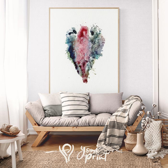 Yoni watercolor print in pink and blue tones above a wooden daybed in a bright interior room.
