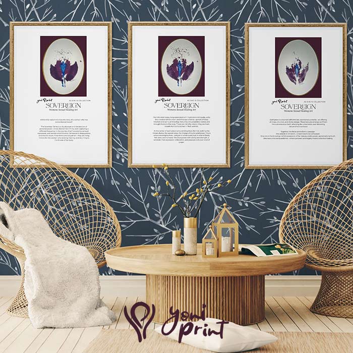 Trio of framed yoni art prints on navy botanical wallpaper above two wicker chairs and a light wood table. 