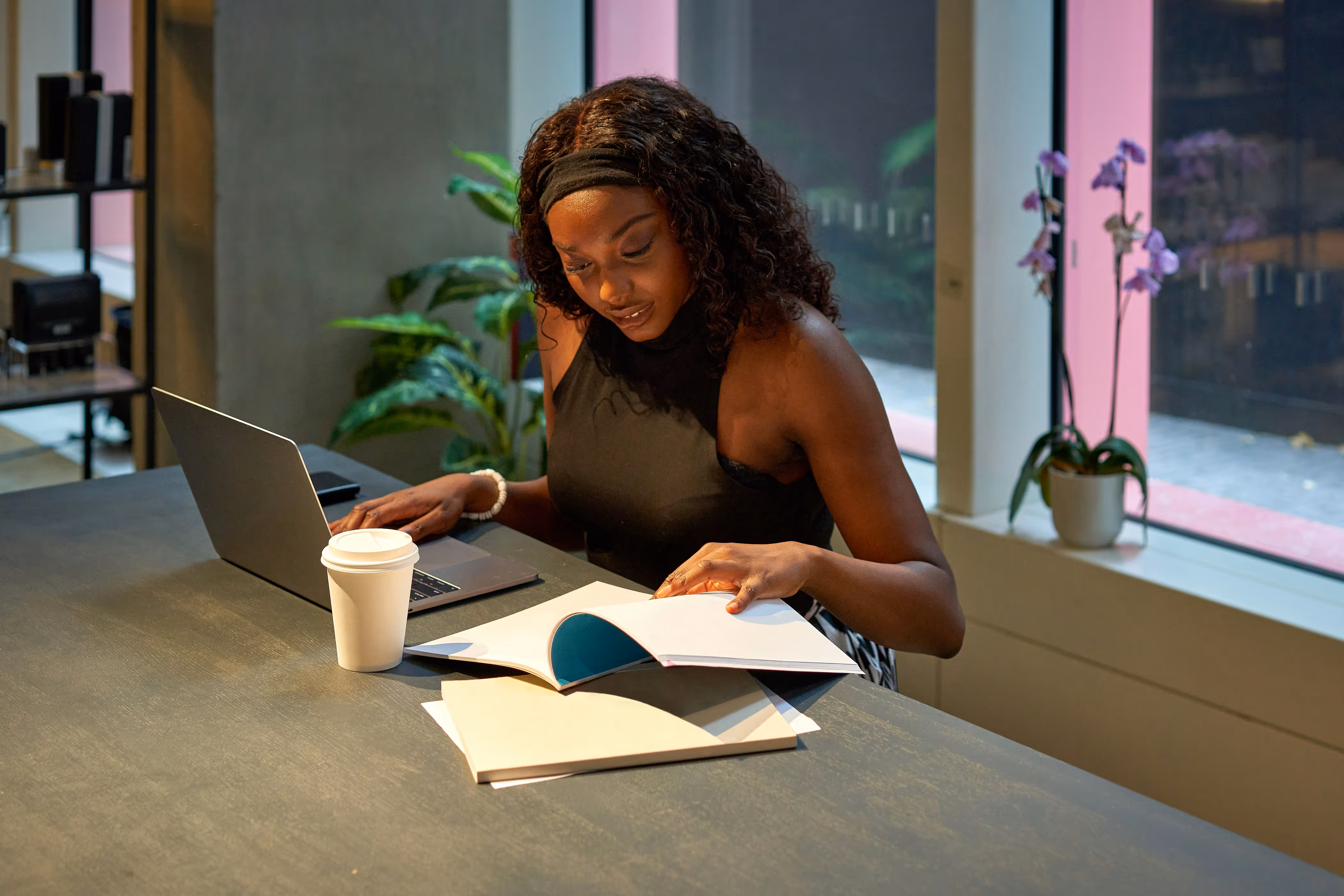 A lady studying and working in a coffee shop
