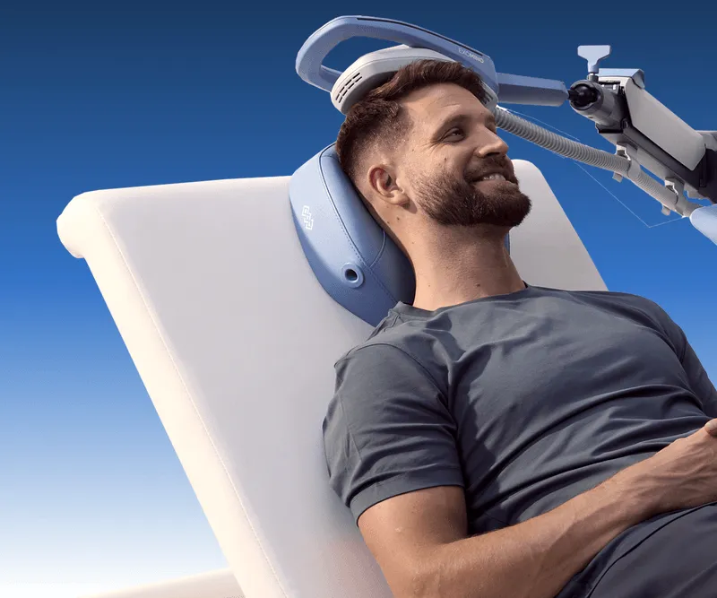 A man laying down with an exomind device on his head.
