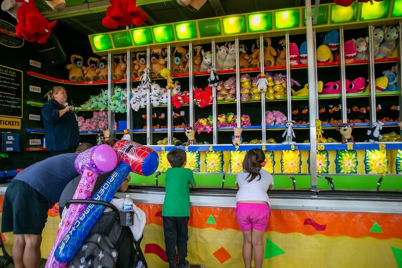 People enjoy rides and games at the Portland Rose Festival City Fair