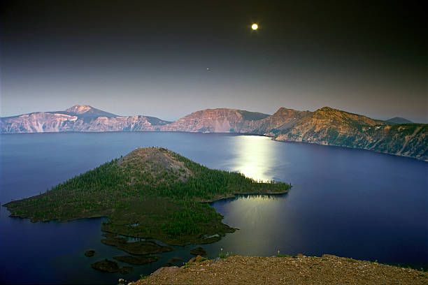 Crater Lake Moon Full moon over the East Rim of Crater Lake National Park, Oregon. crater lake at night stock pictures, royalty-free photos & images