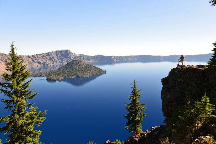 Crater Lake with hiker on high rock face