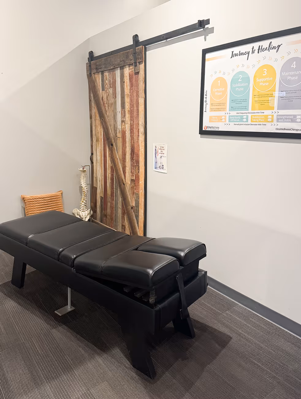 A black bench with a wooden door in front of it.