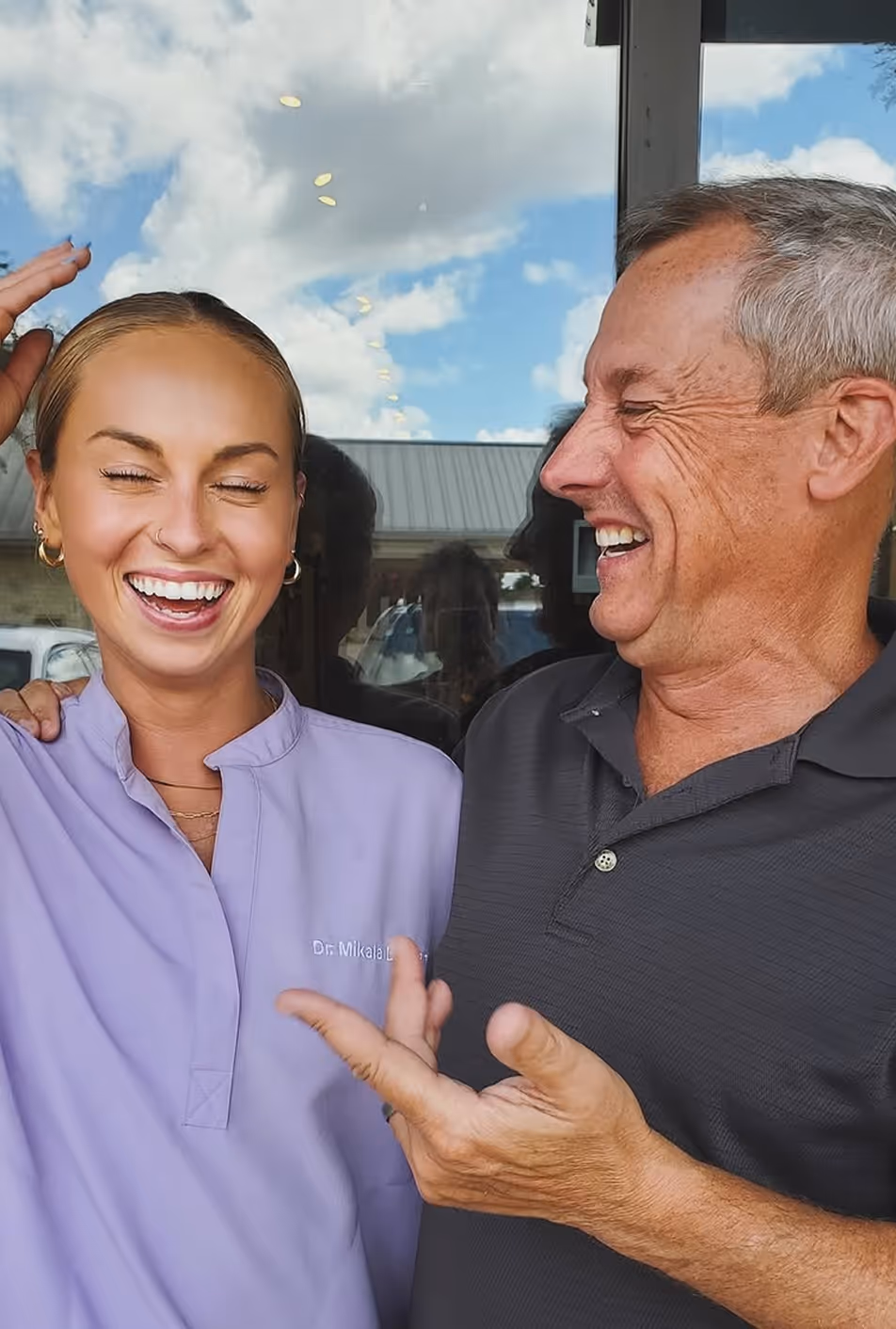 A man and woman are smiling and posing for a picture.