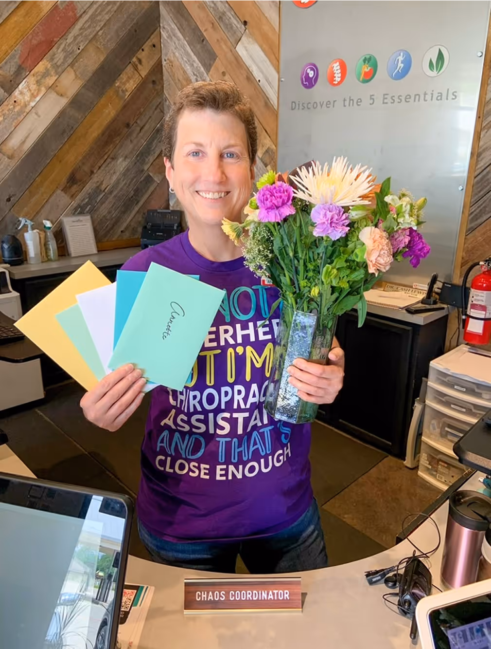 A woman holding a bouquet of flowers and a card that says "not yet".