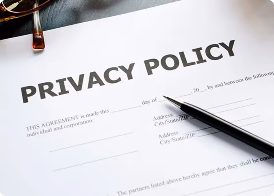 A pen is on a piece of paper that says Privacy Policy.