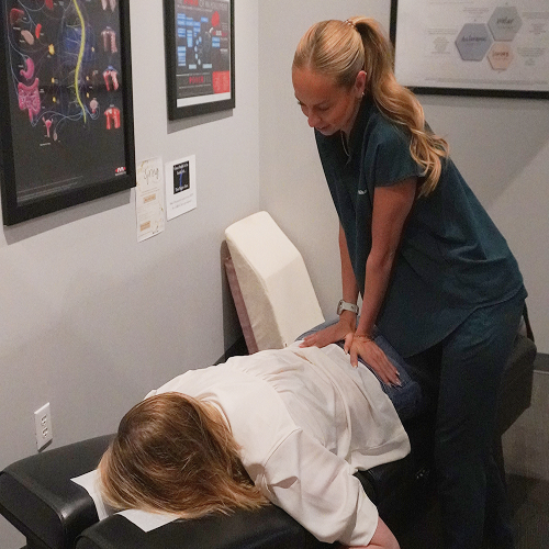 Chiropractor adjusting a patient's back during a treatment session at Elite Wellness Chiropractic