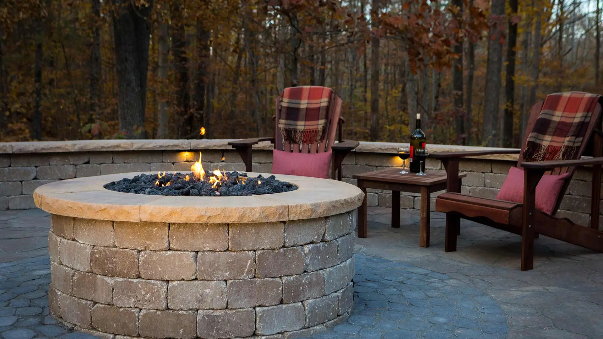 fire pit and chairs with bottle of wine on table
