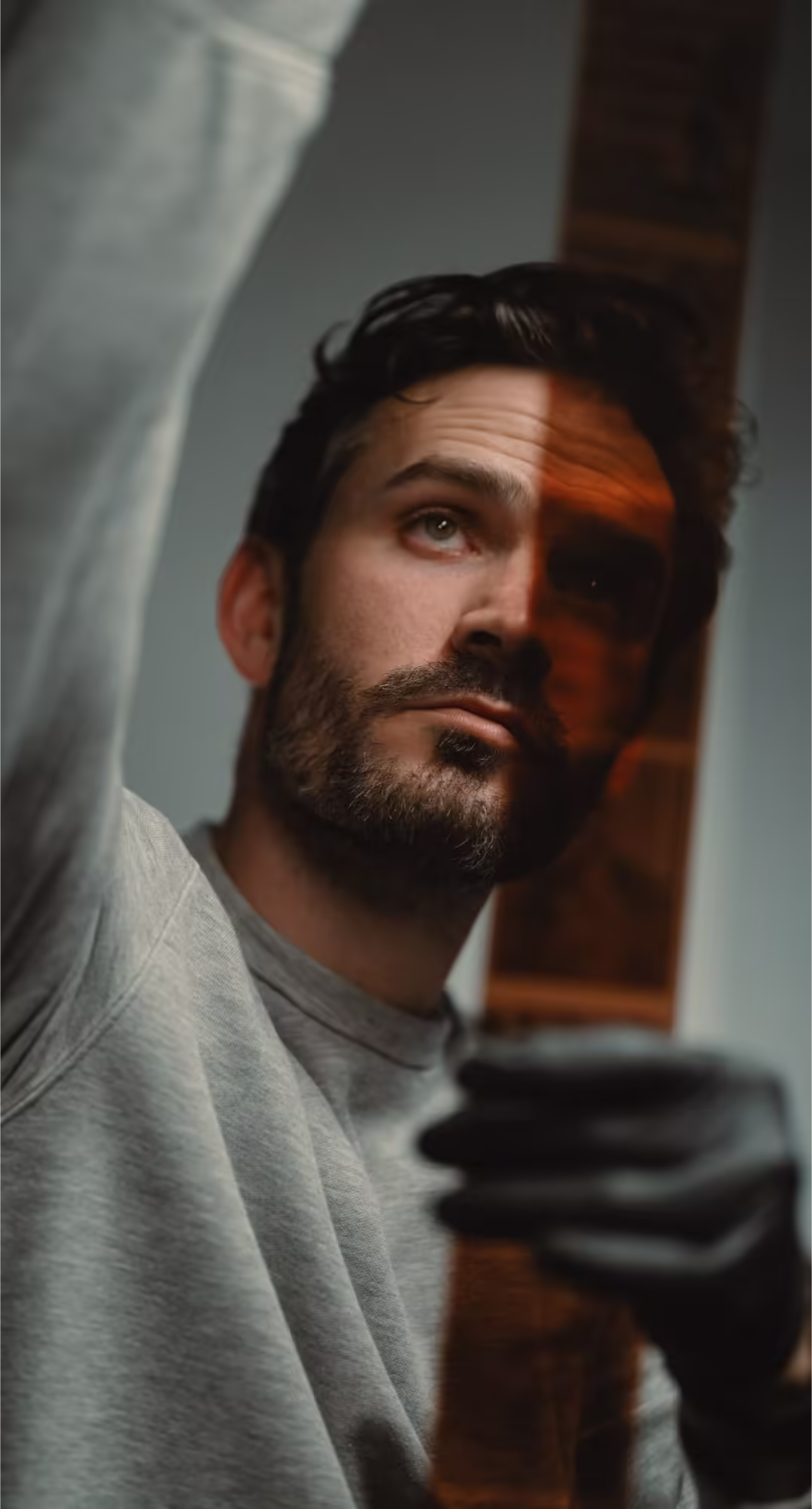 a man looking up with a reflection of his face