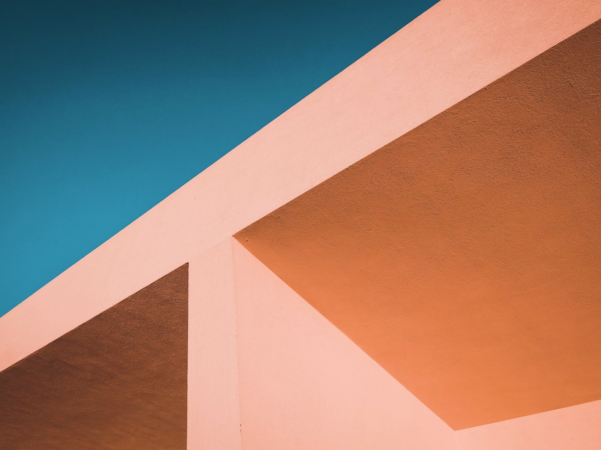 Abstract architectural photograph of sunlit angular walls, used as portfolio placeholder imagery