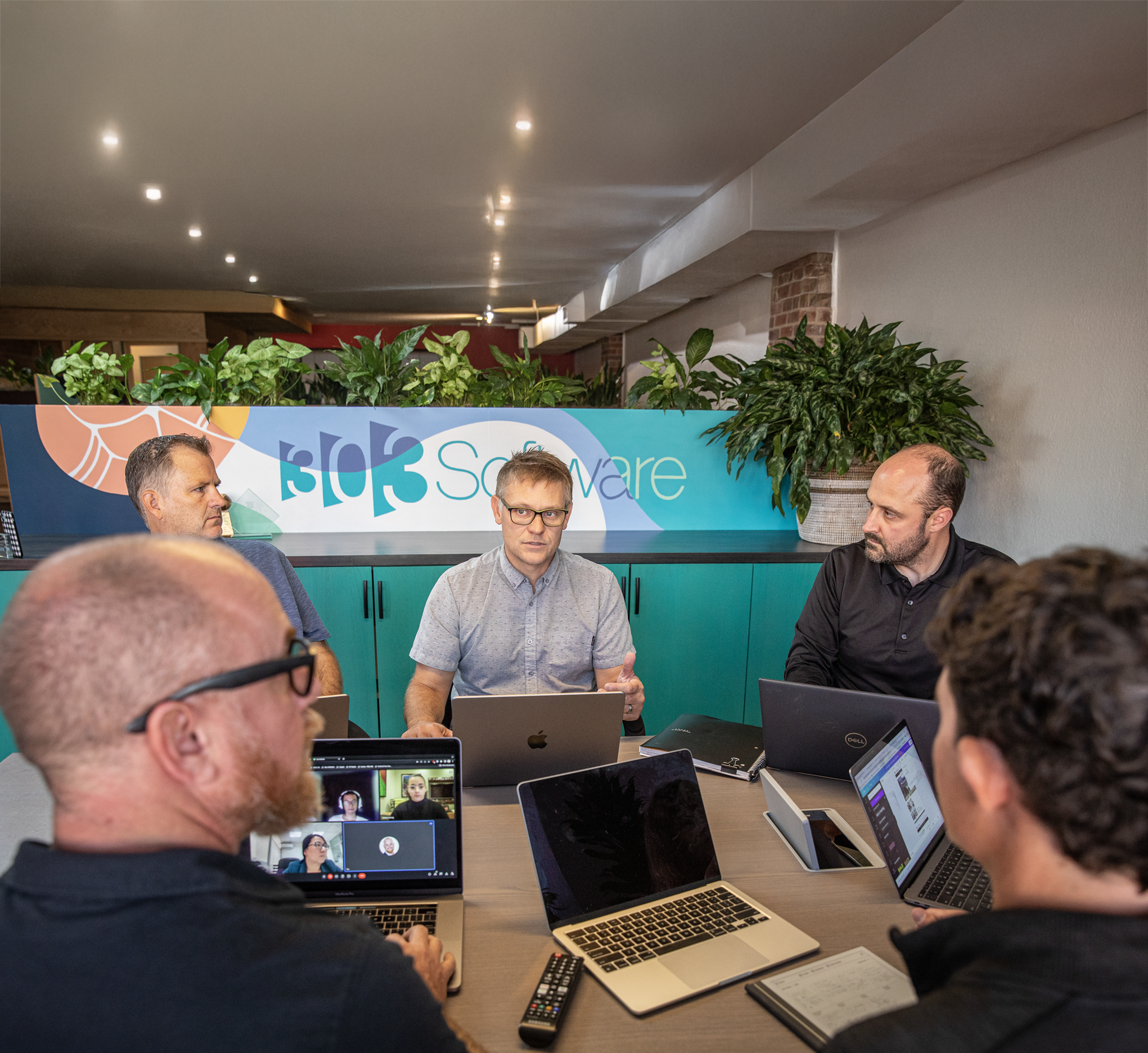 303 Software leadership team collaborating during a strategy meeting in the Denver office.