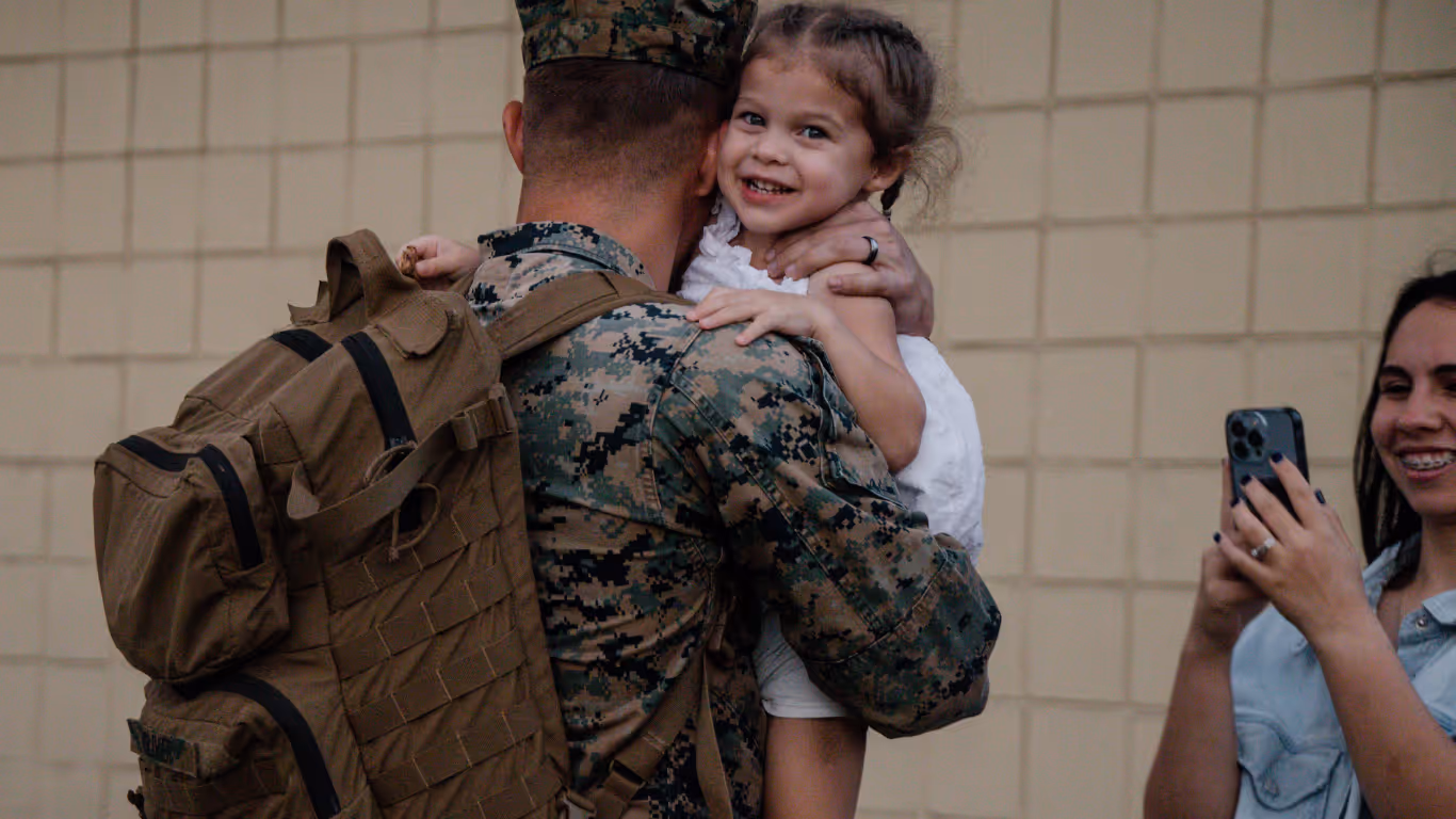 A soldier holding a child.