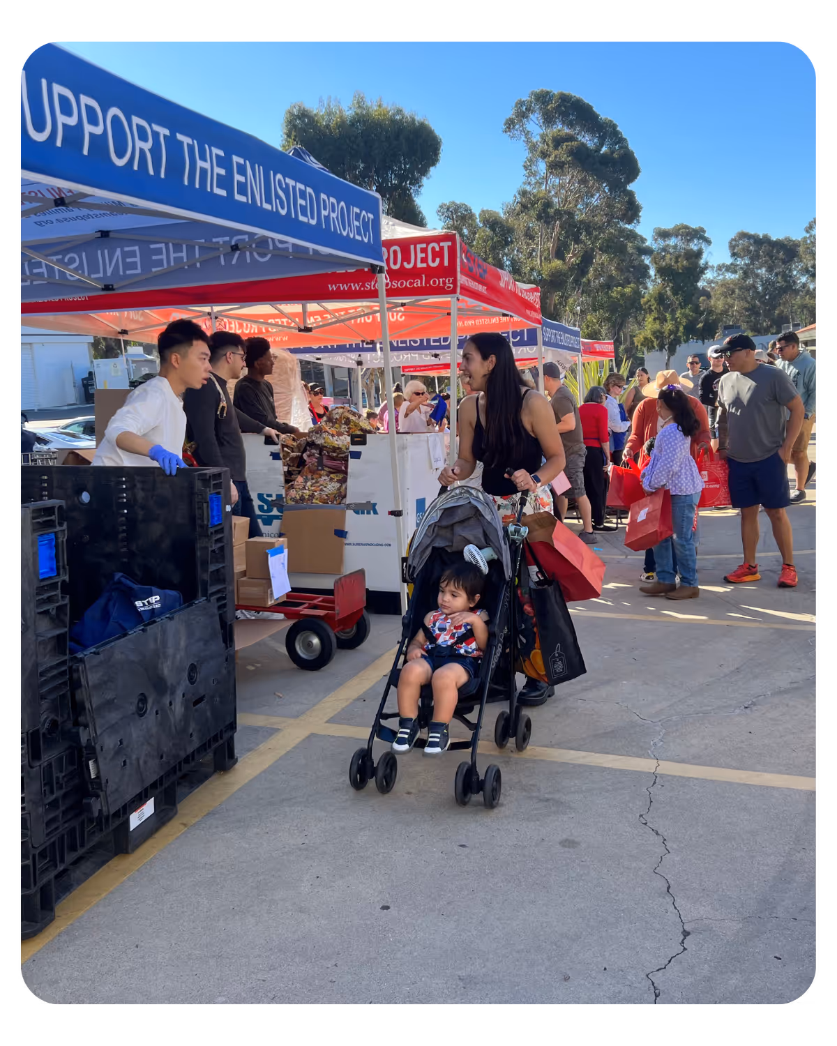 A woman pushing a baby in a stroller.