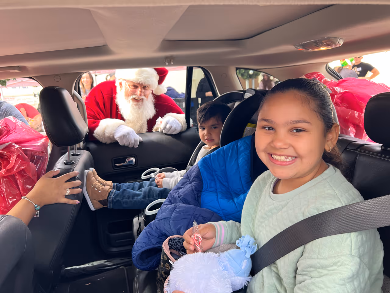 military family in car getting presents.