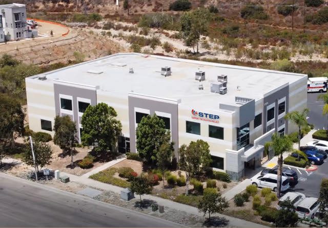 A large white building with a blue sign that says step.