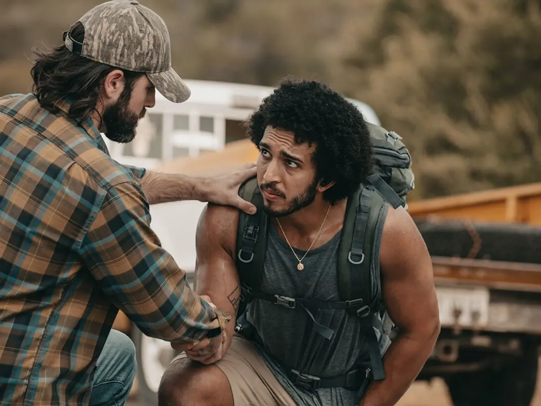 A man with a backpack and a hat on his head.