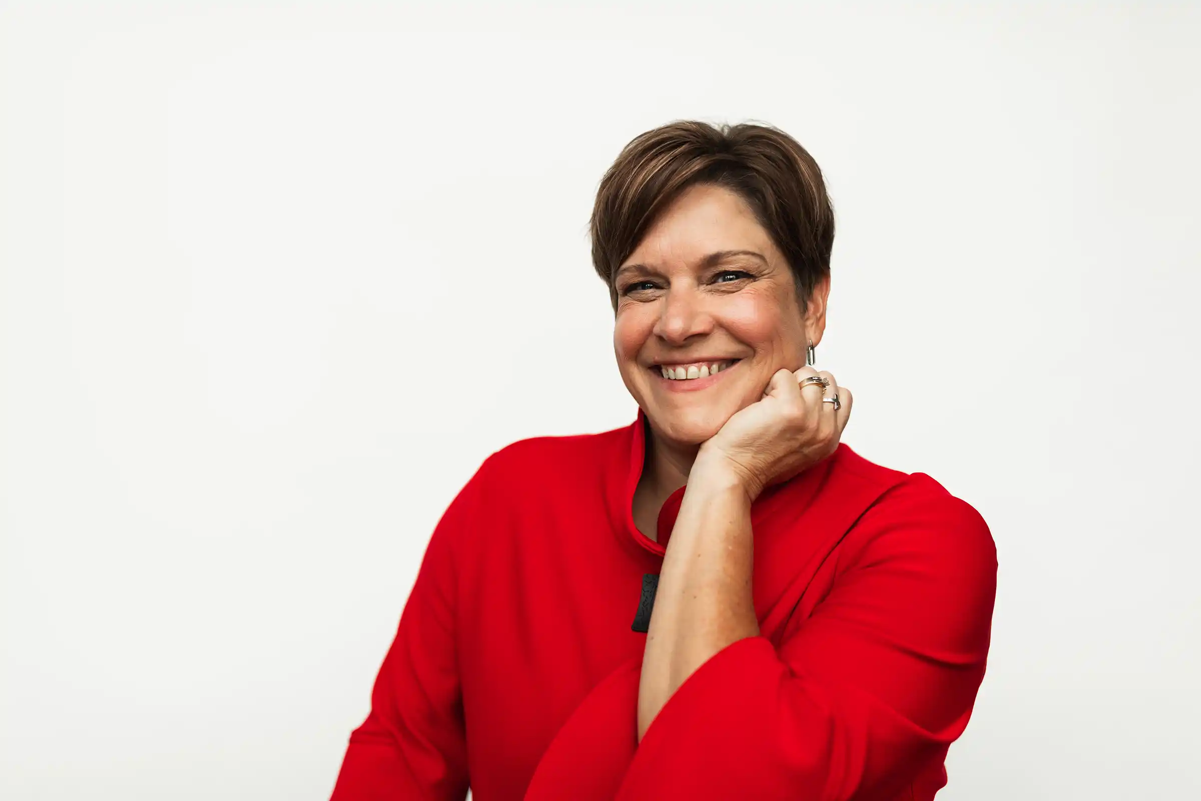 Portrait of Kathy Wulf-Tays, resting head casually on her hand.