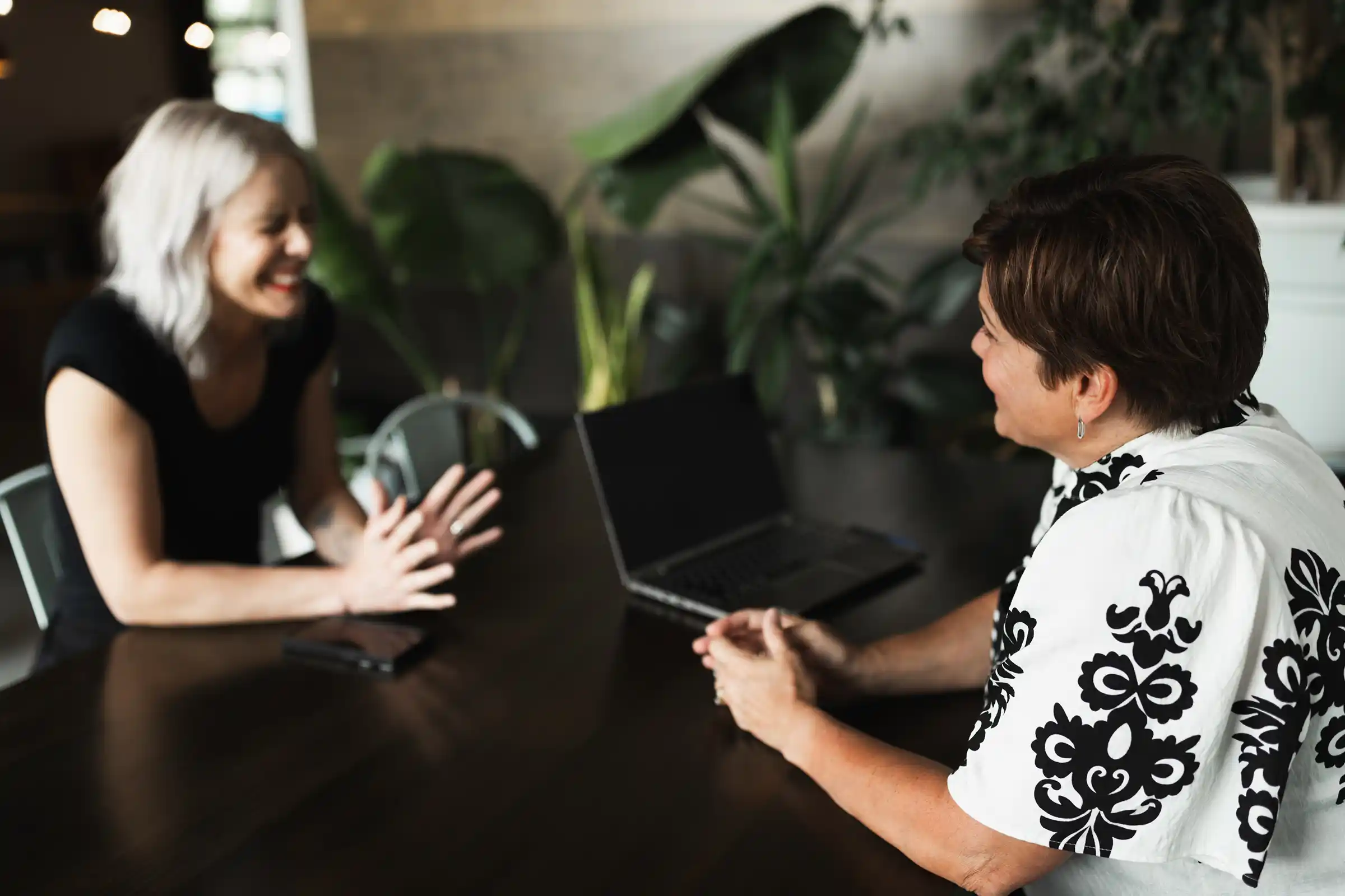 Kathy from KWT Consulting engages in a relaxed leadership coaching session with a client, fostering authentic connection and trust during an organizational development strategy discussion.