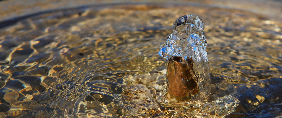 Close up on the bubbling mechanism on a water feature installed by a home in Graham, NC.