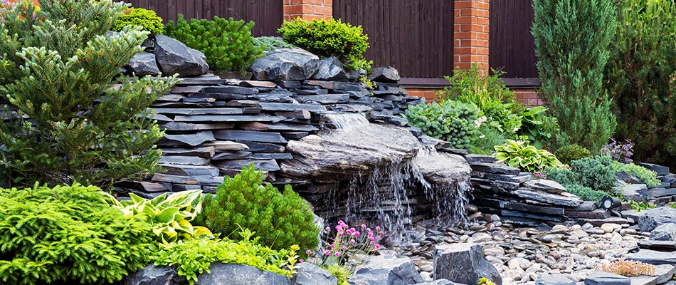 Pondless waterfall feature installed in landscape in Greensboro, NC.