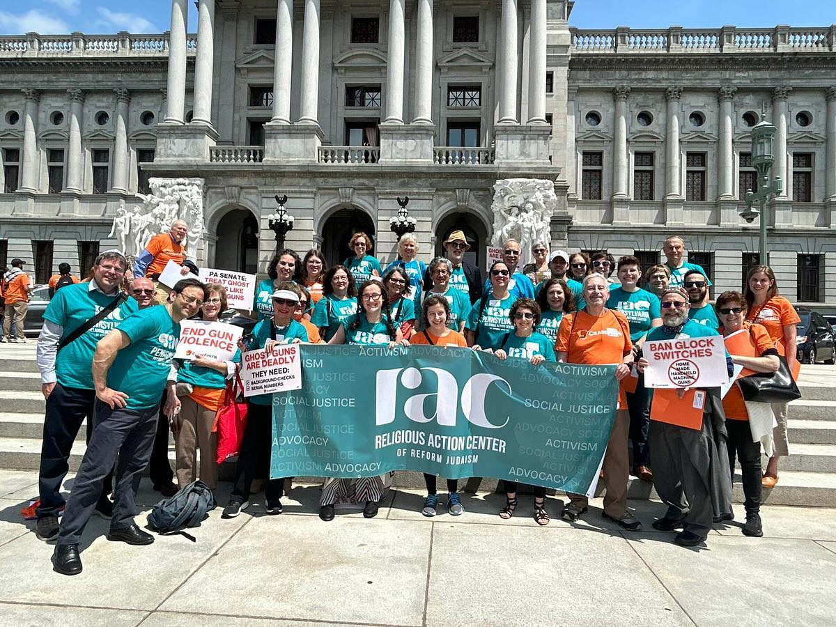 An RAC protest with people holding signs and banners.