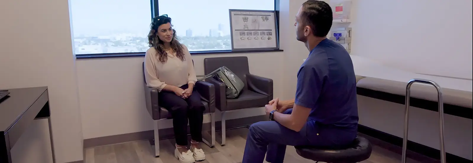 Dr.Yashar and woman in Los Angeles CA discussing neurosurgery spine surgery and brain surgery