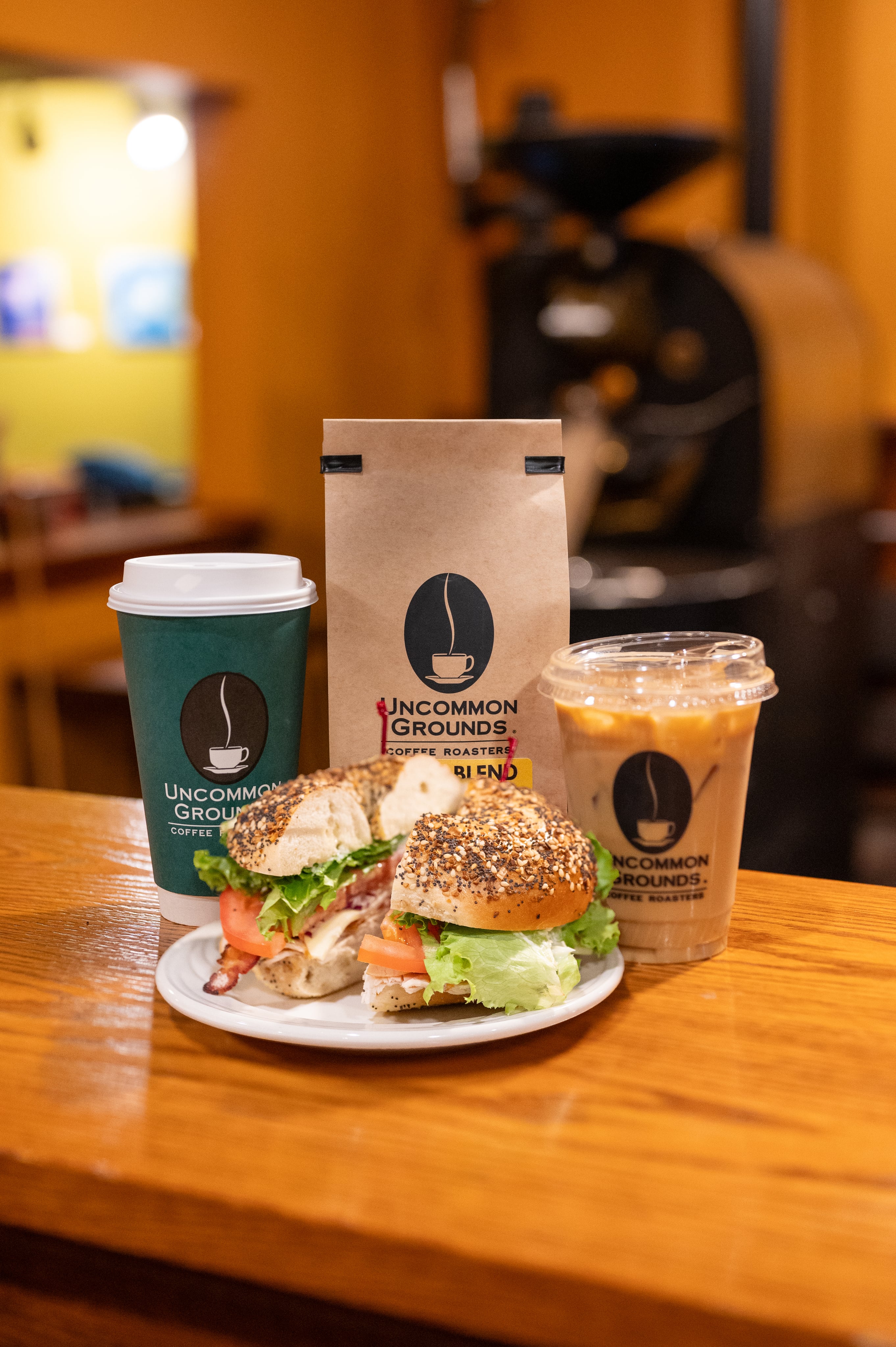 a bagel a coffee and coffee beans