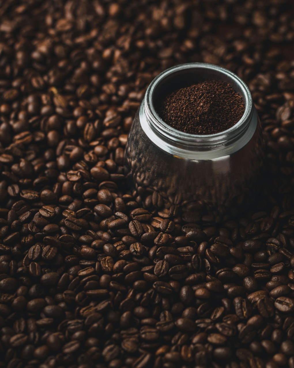 a cup of coffee inside coffee beans