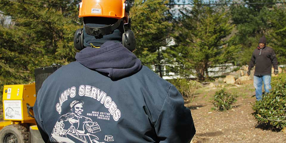 Sam Crowder remotely controlling a stump grinder