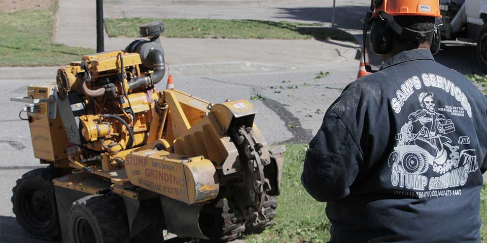 Sam Crowder remotely controlling a stump grinder