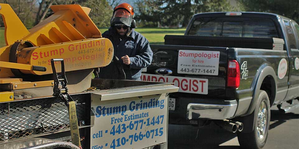 Sam Crowder loading up a stump grinder onto a trailer