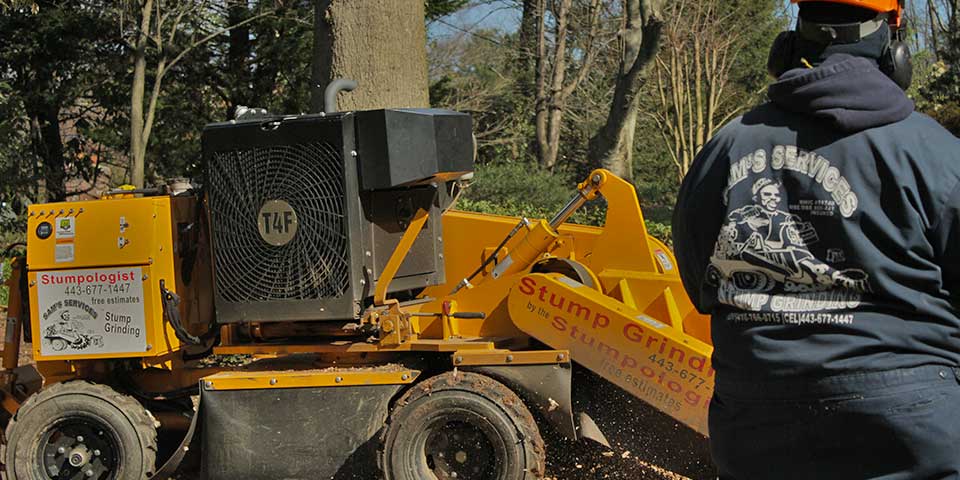Sam Crowder remotely controlling a stump grinder