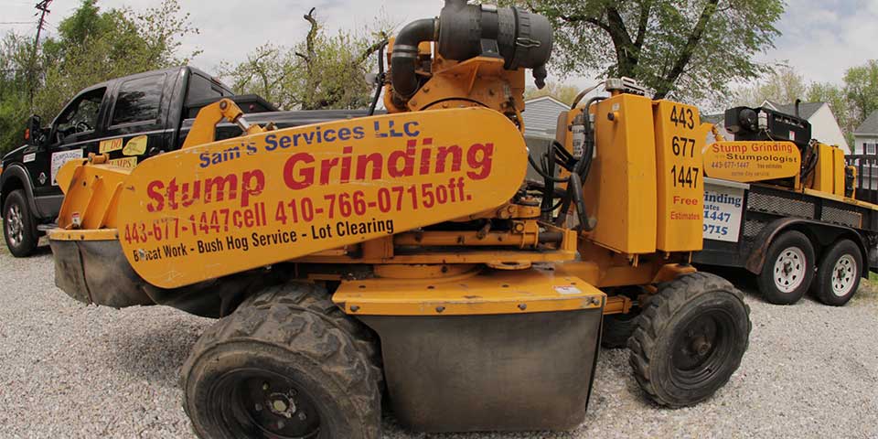 A side profile image of a stump grinder