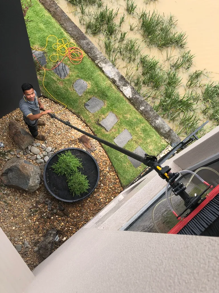 Ultra exterior cleaning employee using a pressure cleaner