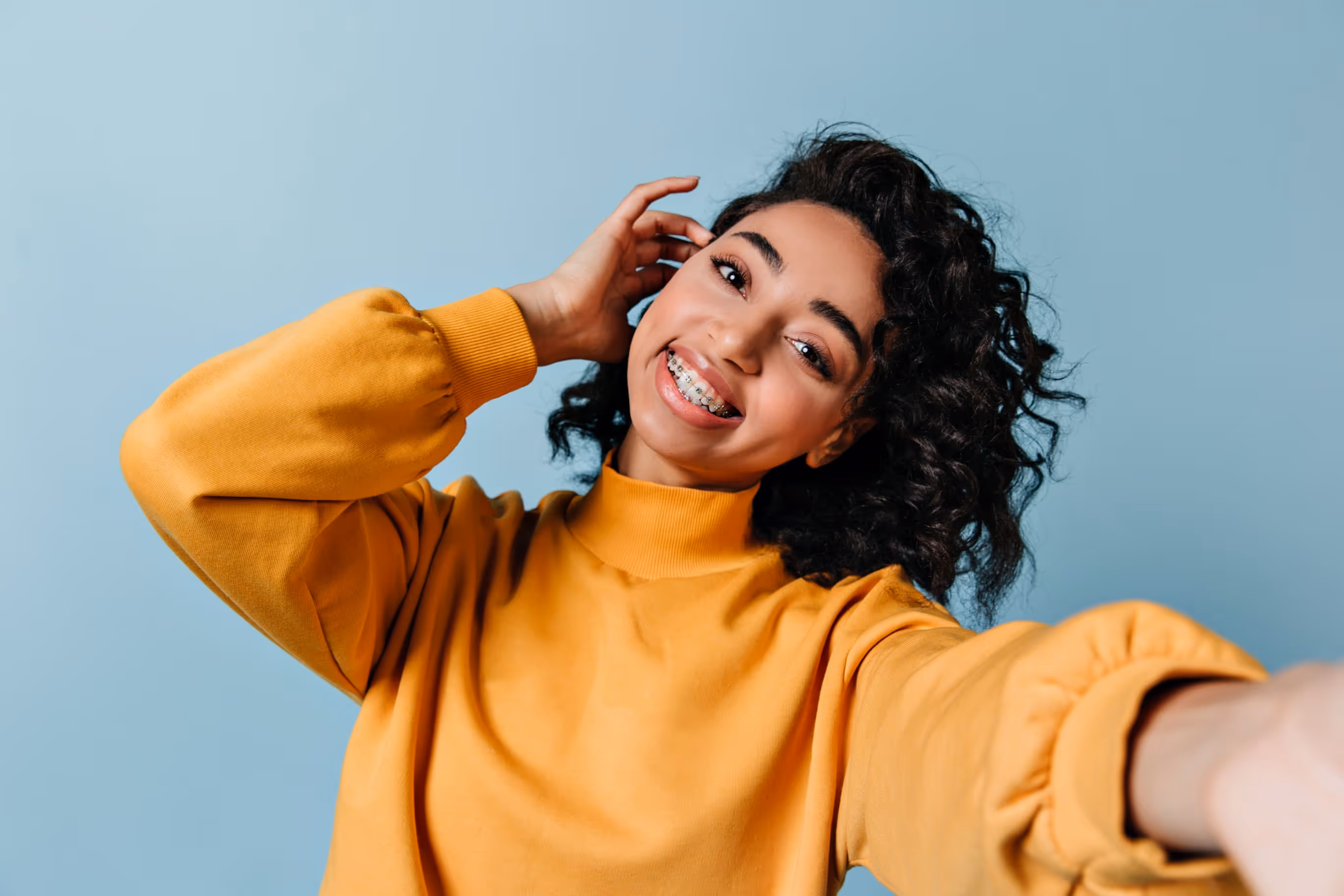 Smiling patient after Invisalign® treatment at Opalign Orthodontics in Houston, TX