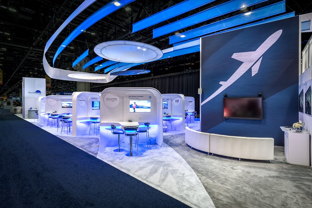 Innovative exhibition booth design with curved structures, LED lighting, and open visitor layout