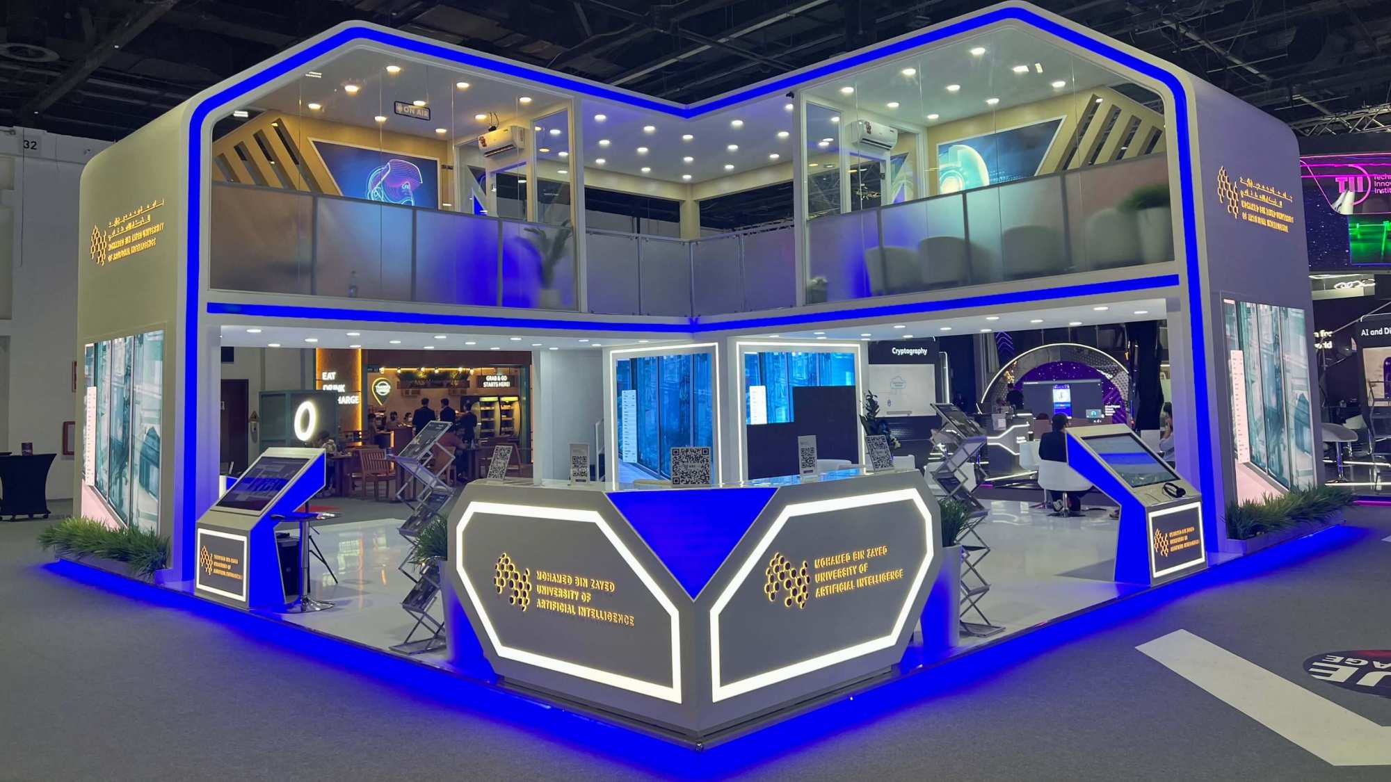 Double-story exhibition stand design with custom fabrication, LED accents, and branded reception area