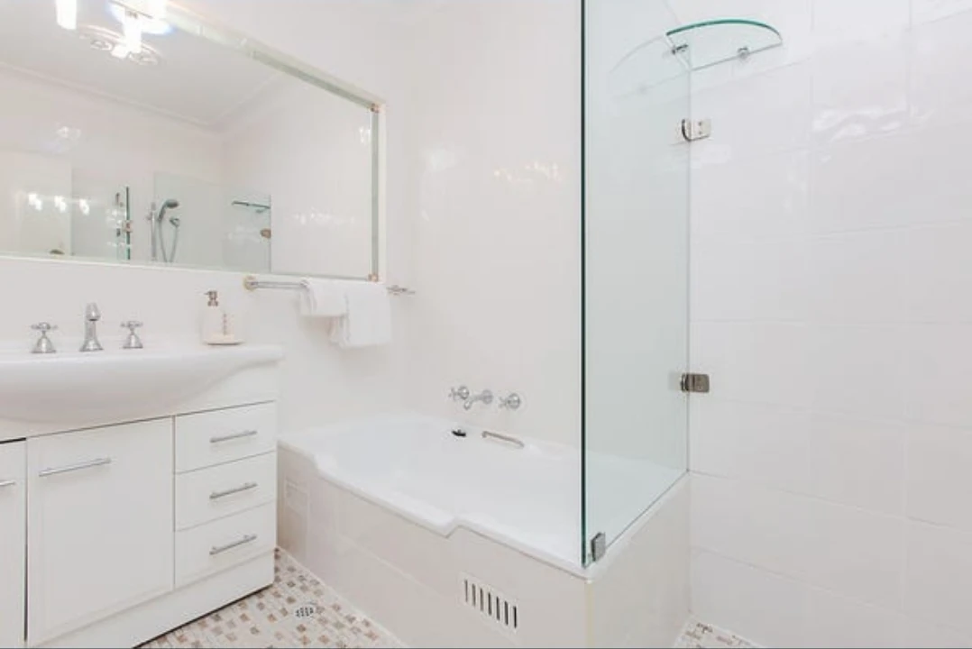 Belair bathroom before renovation, original bath, shower screen and vanity