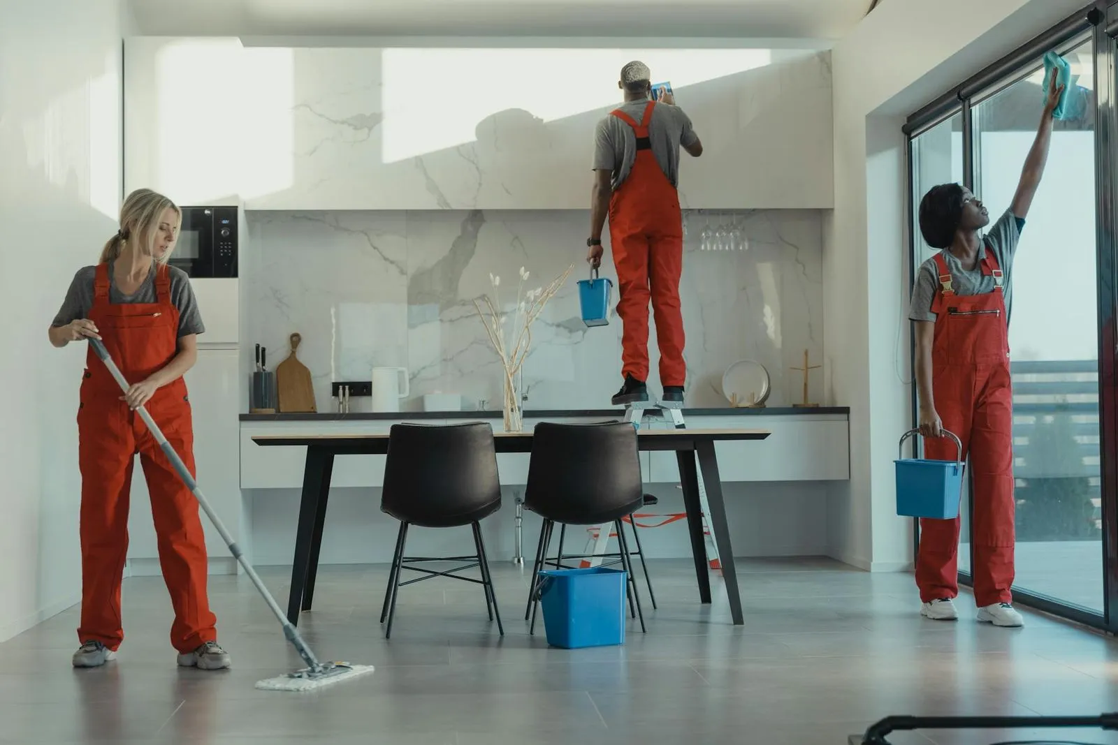A group of cleaners each cleaning their own section of the room