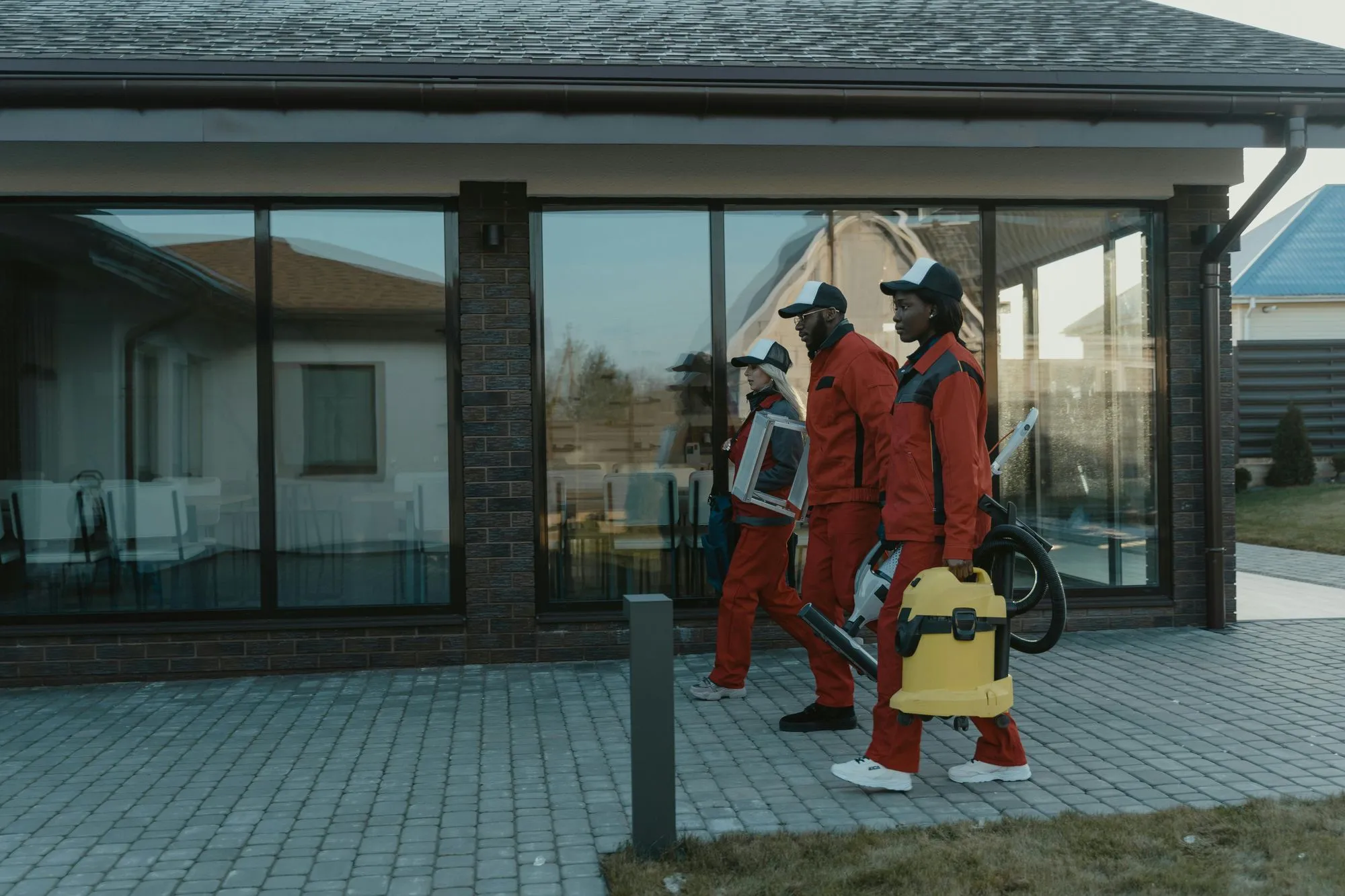 A group of cleaning carrying their equipment 