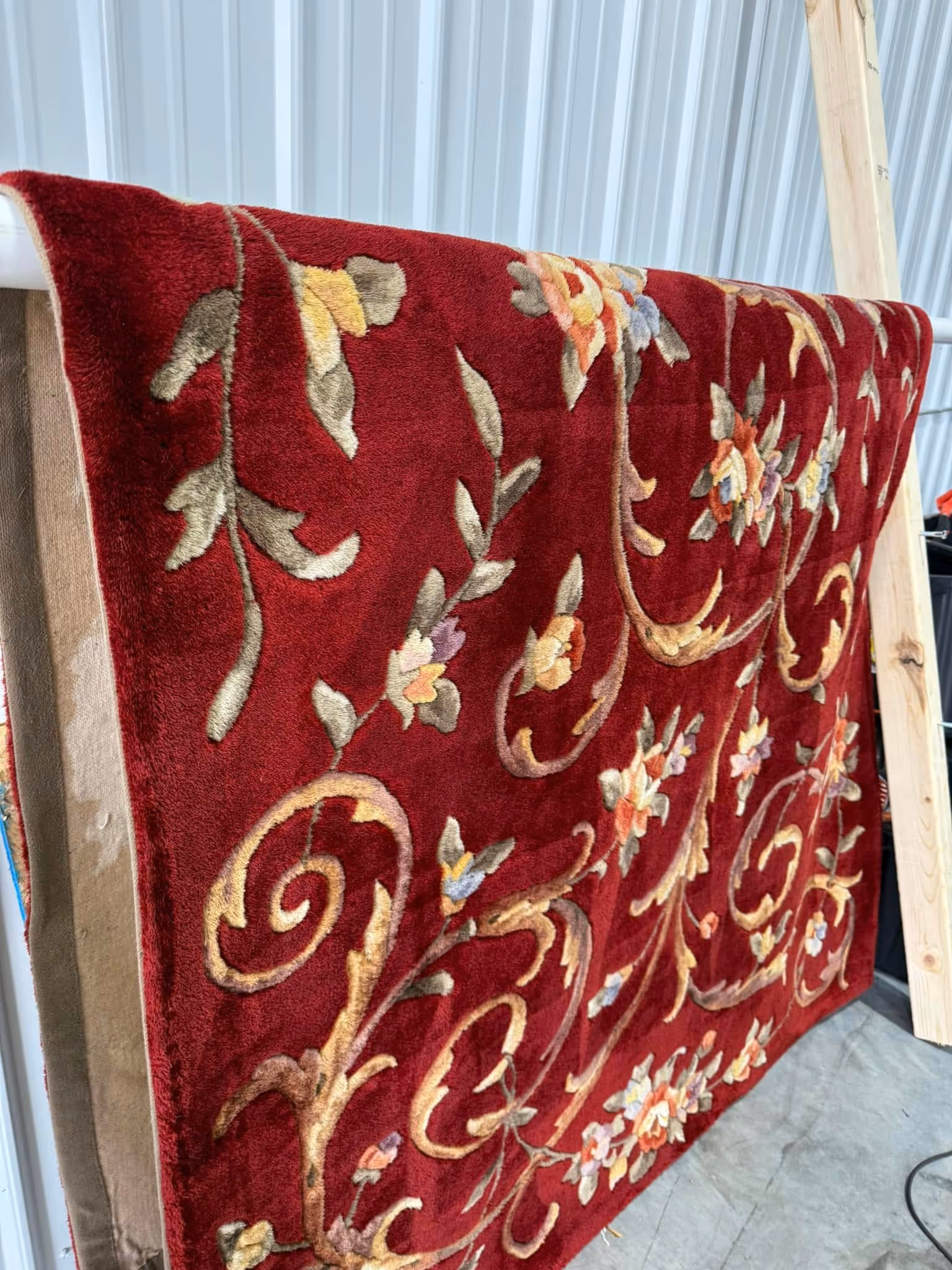 A Bright red rug that has recently been cleaned