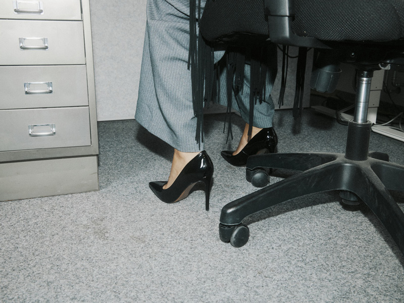 High heels beside an office chair and filing cabinet