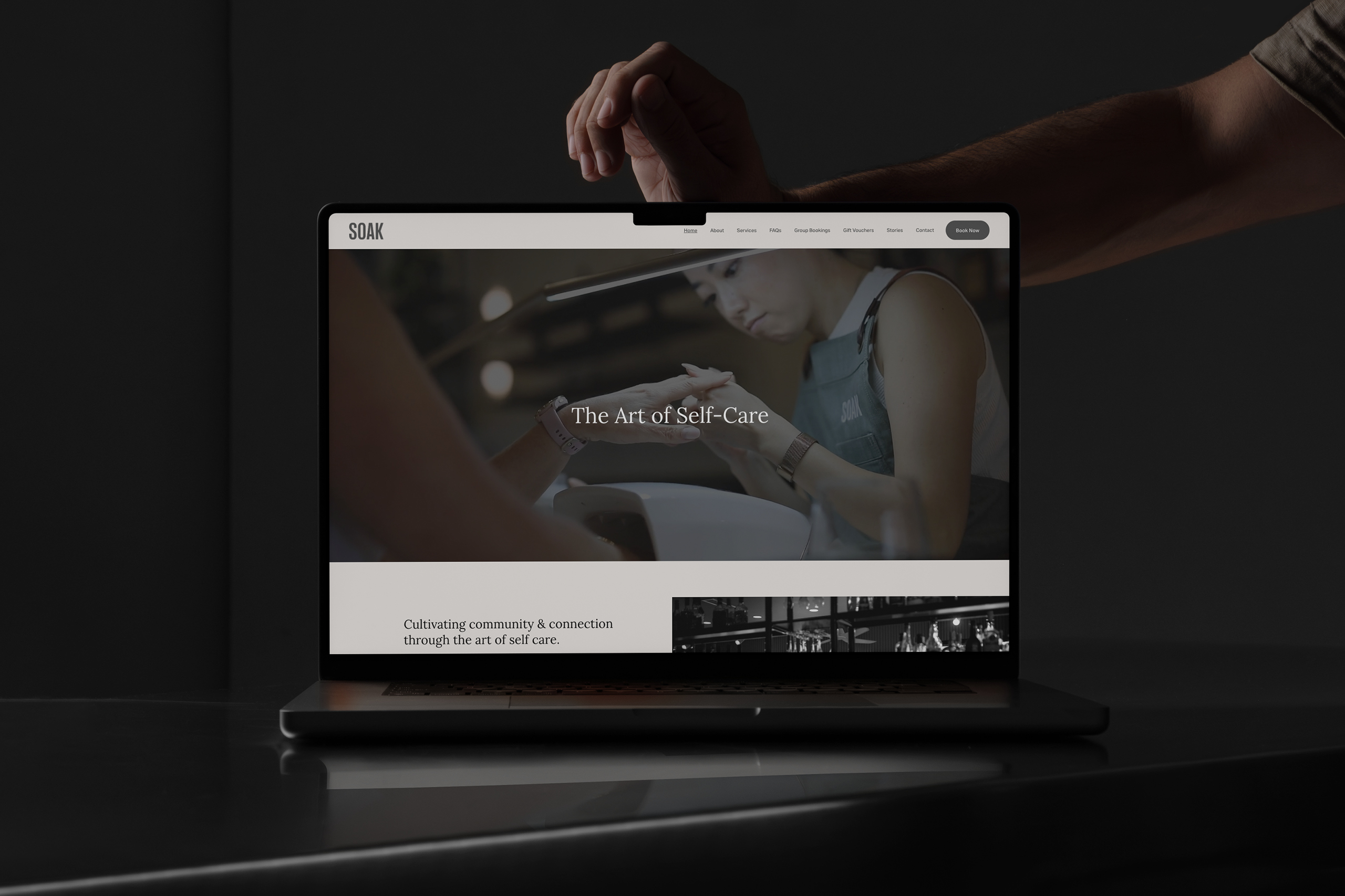 SOAK website homepage, 'The Art of Self-Care', shown on a laptop
