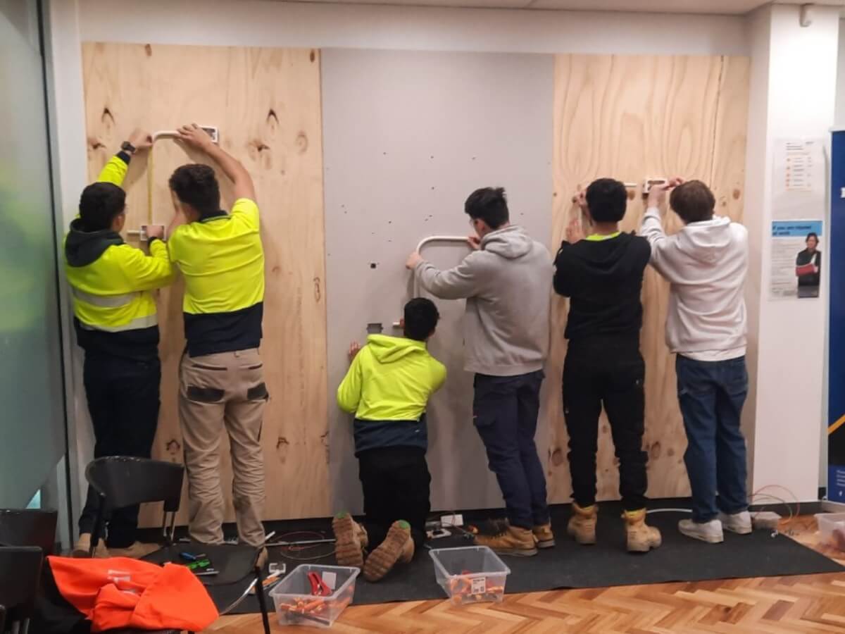 Beginner level apprentices training with electrical cables and circuits at Impact Apprentices Skill and Development Centre in Collingwood