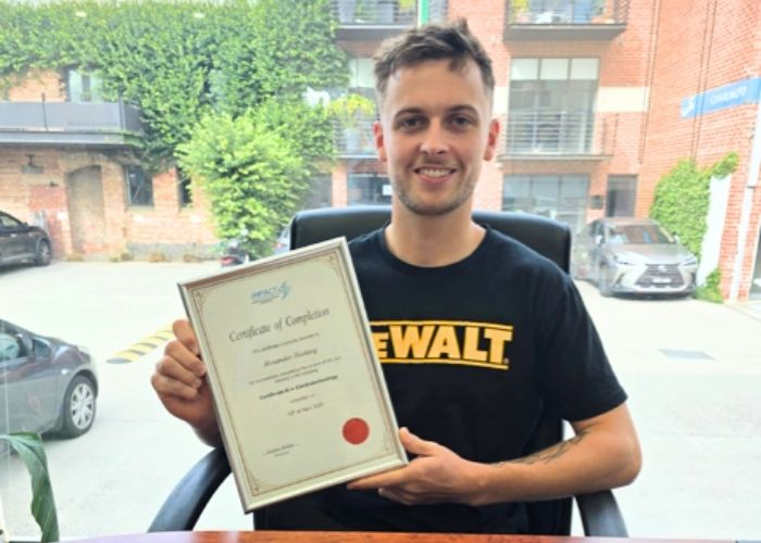 One of Impact Apprentices' holding the completion certificate