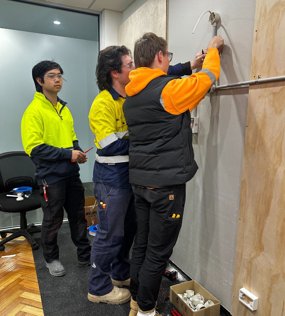 Apprentices working on the electrical board