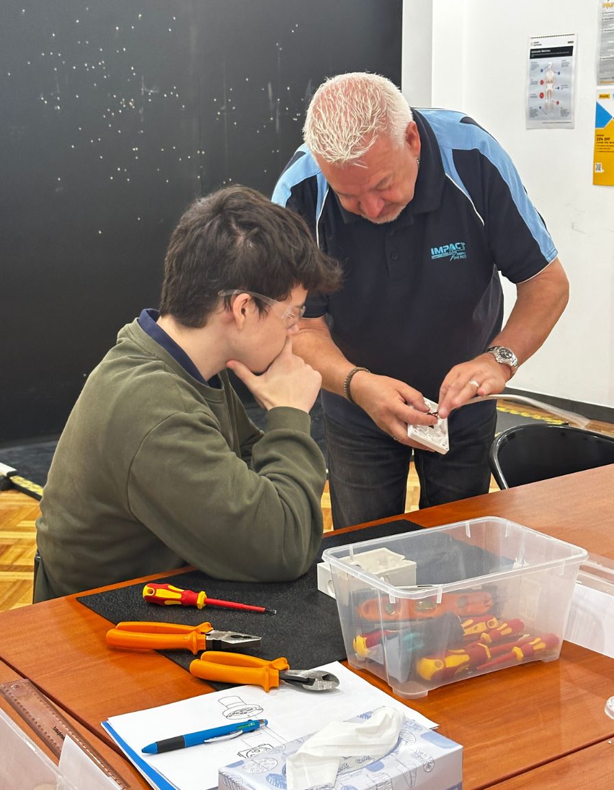 Ian, the instructor of the Skills Centre showing a student the different parts of a circuit