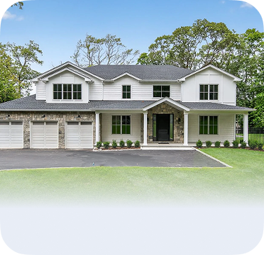 An image of a large two-story house in Syosset with three-car garage and front porch.