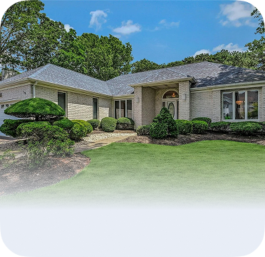 An image of a single-story house in Holbrook with a landscaped front yard